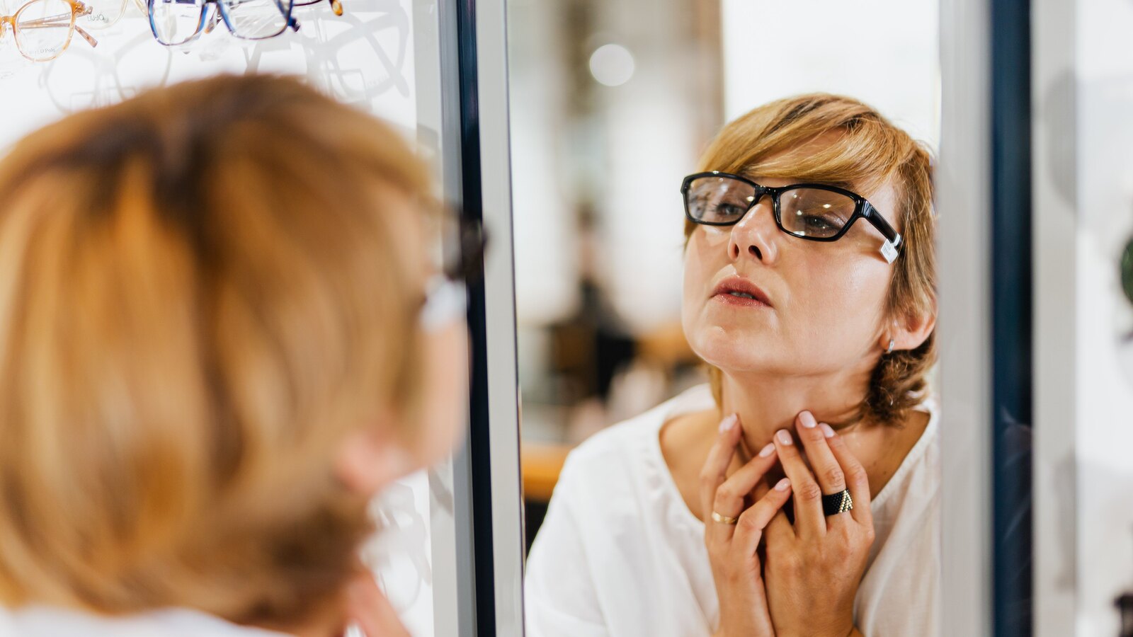 Dispensing optician helping a customer choose frames