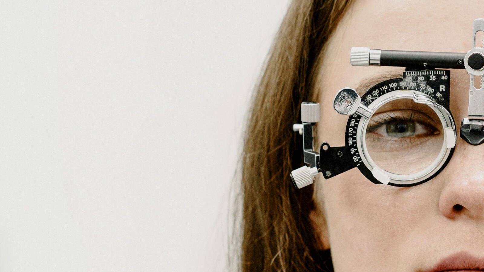 Optometrist checking a patient's eyes with a phoropter